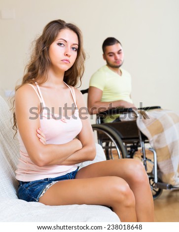 Quarrel in family with handicapped unhappy husband at background