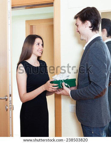 woman gives a beautiful gift to the man at the door