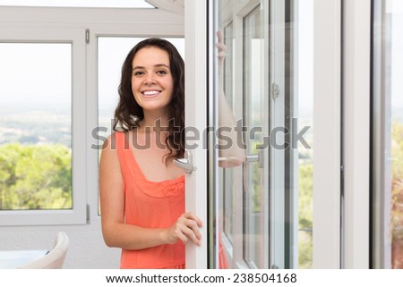 Beautiful housewife is happy to have new plastic windows