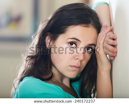 crying woman in depression in the wall in his house