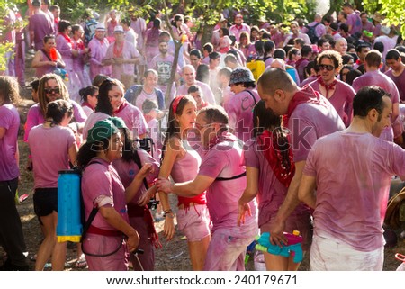 HARO, SPAIN - JUNE 29, 2014:   Batalla del vino - wine madness in Haro, Spain. People fighting with wine from botas, bottles and buckets