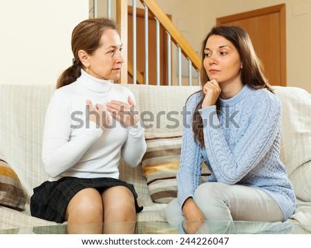 mother with  teen daughter having serious conversation in home
