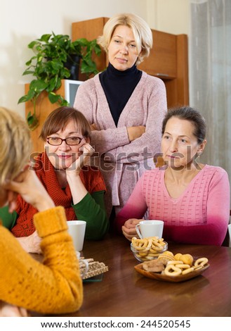 Female pensioners listening to sad story of their friend indoor