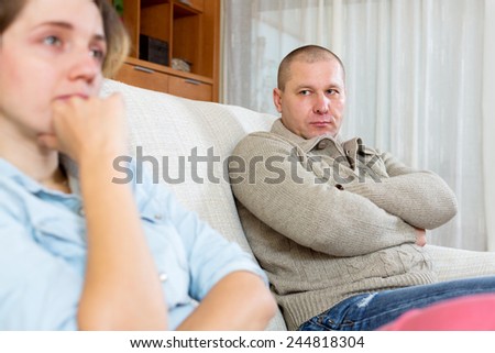 Family quarrel. Angry adult man against and crying young woman