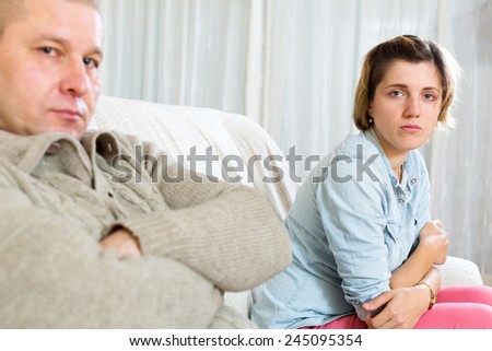 Couple quarrel.Sad ordinary woman against depression man at home