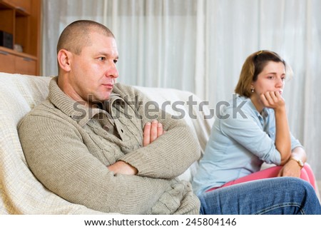 Family quarrel. Angry man against and crying young woman