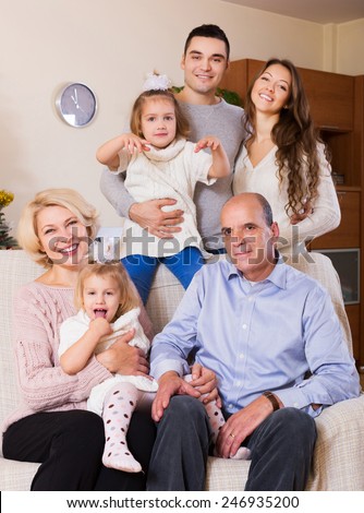 smiling family with grand children at home