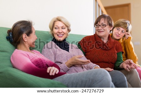 Portrait of senior women having discussion indoor and laughing