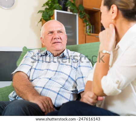 mature family having serious talking in home interior
