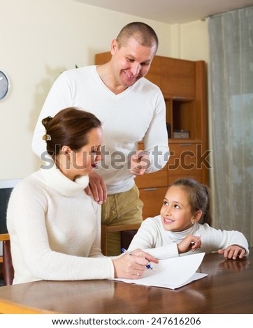 Smiling family with documents at table
