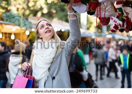 Portrait of female customer near counter with Christmas  and New Year gifts
