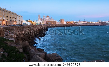 Ocean   embankment and Cathedral in twilight time. Cadiz, Spain