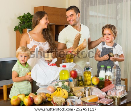 Smiling family with kids came back from supermarket