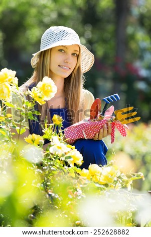 female gardener working in roses plant