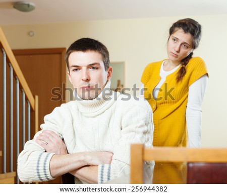 Couple quarrel. Upset  man against unhappy woman  at home
