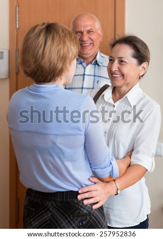 Young woman meeting friends at the door