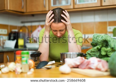 Portrait of unhappy female tired to cook at home