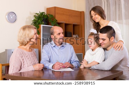 Satisfied relatives sitting at the table and discussing finances