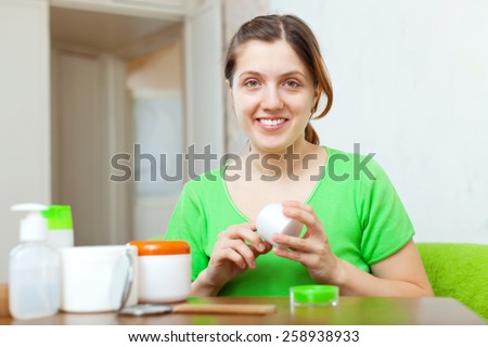 woman caring for her body with cosmetics at home