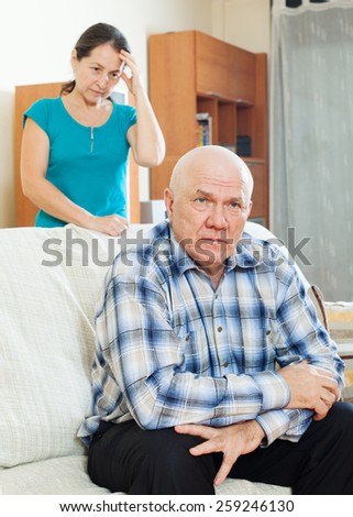 Family quarrel. Unhappy mature man with sad wife