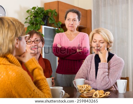 sad  female pensioners  sharing problems at table  indoor