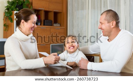 Smiling father with cheerful daughter complete a questionnaire for the employee of the company
