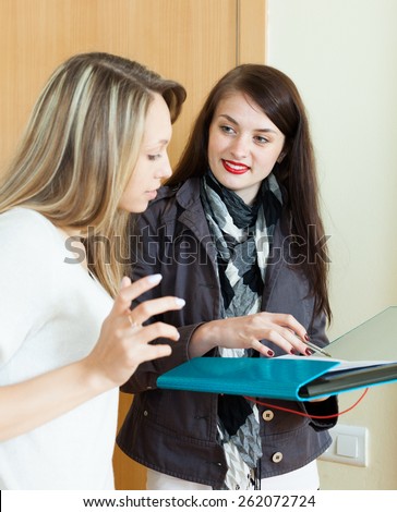 woman answers the questions in door at home. Focus on brunette