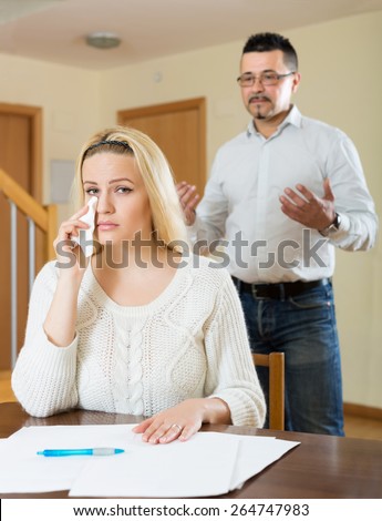 Husband and upset wife having a financial problems