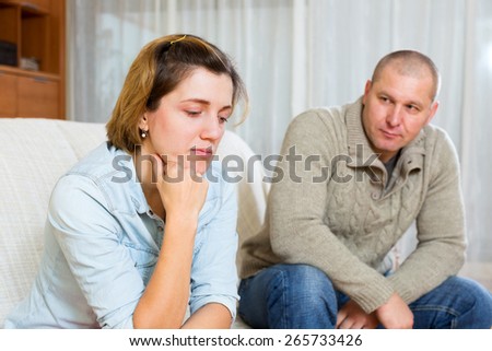 Couple quarrel.Sad young woman against depression man at home