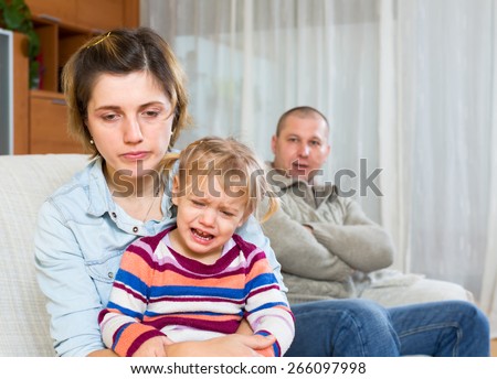 Family sitting on a sofa after a quarell