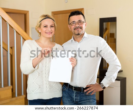 agent giving to woman client keys from flat and papers