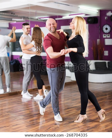 Couples enjoying of partner dance and smiling