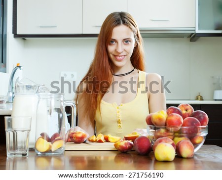 pretty woman cooking beverages with peaches at home kitchen