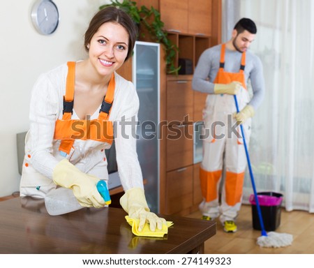 Cleaning premises smiling team is ready to work in room