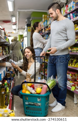 Young american family purchasing food for week at supermarket