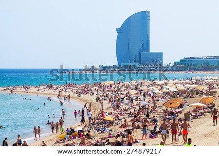 BARCELONA SPAIN JUNE 28 Barceloneta Beach against W Barcelona Hotel in June 28 2013 in Barcelona Spain Barceloneta Beach one of the most popular in the city BARCELONA SPAIN JUNE 28 Barceloneta Beach against W Barcelona Hotel in June 28 2013 in Barcelona Spain Barceloneta Beach one of the most popular in the city