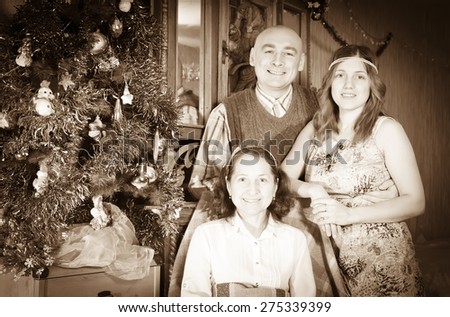 Vintage photo of happy married couple visiting mom for Christmas