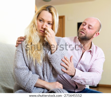 Man asking for forgiveness from sad woman