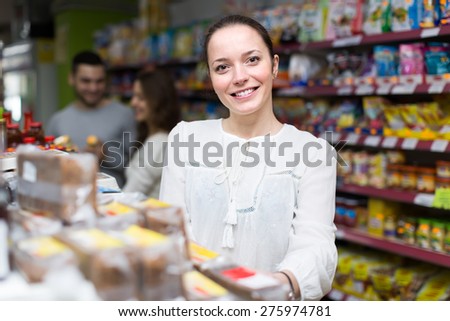 Young caucasian woman purchasing food for week at supermarket