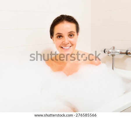Pretty woman relaxing with foam in bath