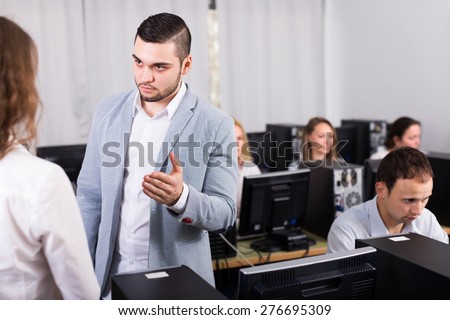 Strict young boss and crying clerk at open space working area