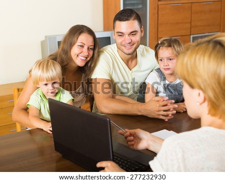 Young parents and two daughters sitting in front of social worker