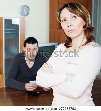 Financial problems in family. Sad woman against man with money