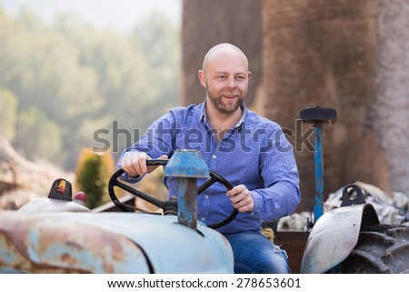 happy mechanic reparing old agrimotors at farm