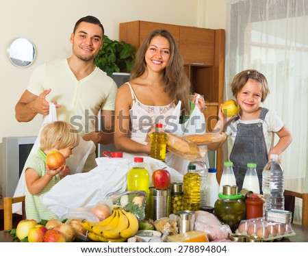 Happy smiling family with two children came back from supermarket