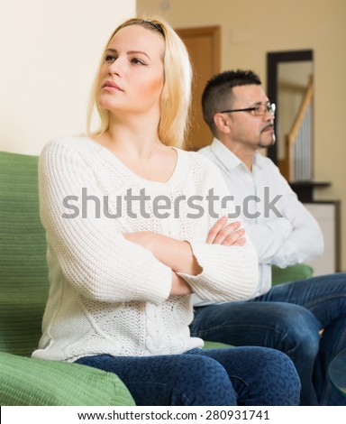 Couple conflict. Portrait of unhappy woman after quarrel in living room at the home