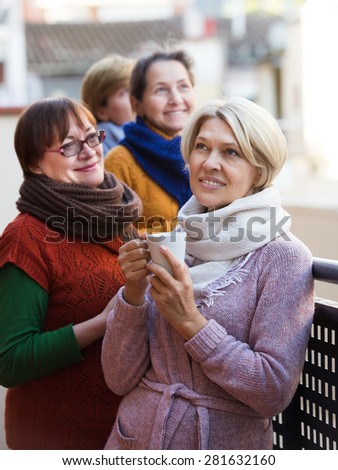 Senior female pensioners relaxing with the cup of coffee on balcony