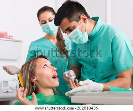 Portrait of doctor and frightened patient at medicine clinic