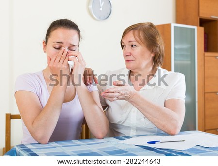 serious women with  documents at table in home or office interior