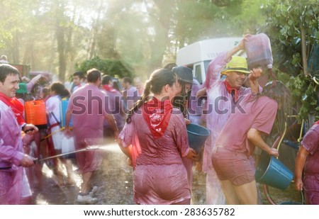 HARO, SPAIN - JUNE 29, 2014: Happy people during Batalla del vino - wine madness in Haro, Spain. People fighting with wine from botas, bottles and buckets